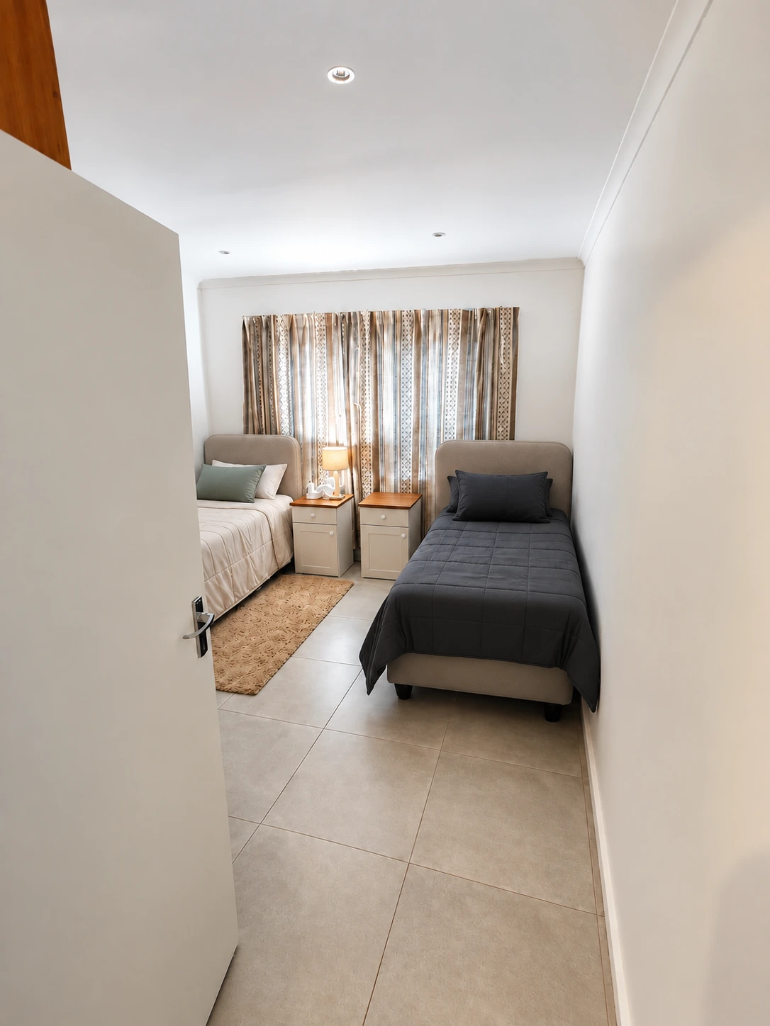 Digitally styled two-bed bedroom, unoccupied, with neatly made beds, headboards and bedside tables
